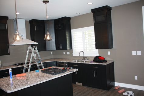 We have the same wall color...& These black kitchen cabinets look beautiful with it Grey Walls White Trim, Black And Grey Kitchen, Grey Kitchen Walls, Paint For Kitchen Walls, Gray Walls, Table Farmhouse, Kitchen Wall Colors, Black Kitchen Cabinets, New Kitchen Cabinets