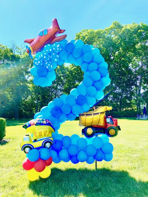 Giant balloon yard number. Transportation theme birthday balloons. Transportation Birthday Balloon Garland, 2nd Birthday Transportation Theme, Transportation Birthday Theme Decor, Car Theme Balloon Decoration, Number Themed Birthday Party, 2nd Year Birthday Ideas Boys, Transportation Party Decorations, Car Theme Birthday Party Decorations, Transportation Party Ideas