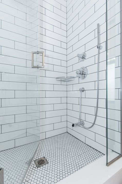 Classic white subway tiled shower with Soho 4x16 glossy tile. 1x1 hex tiled shower floor with contrasting grout.