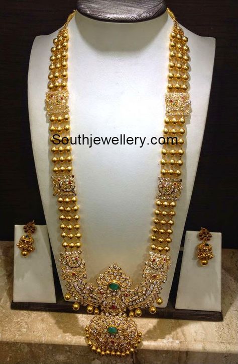 22 carat gold gundla haram with beautiful peacock design stones pendant studded with cz stones, rubies and emeralds. Weight: 110 grams For inquiries contact on Whatsapp: +91 97 00 009000 or Email: dharmesh25@yahoo.com Related Posts72 Grams Gundla Mala with Pachi PendantKundan Long HaramUncut Gold Balls Necklace and Haram Set85 Grams Chandraharam with Side PendantsAntique Gold Saree Inspiration, Unique Saree, Haram Designs, Gold Haram, New Kurti Designs, New Kurti, Outfits Unique, Gold Jewelry Simple Necklace, Beautiful Gold Necklaces