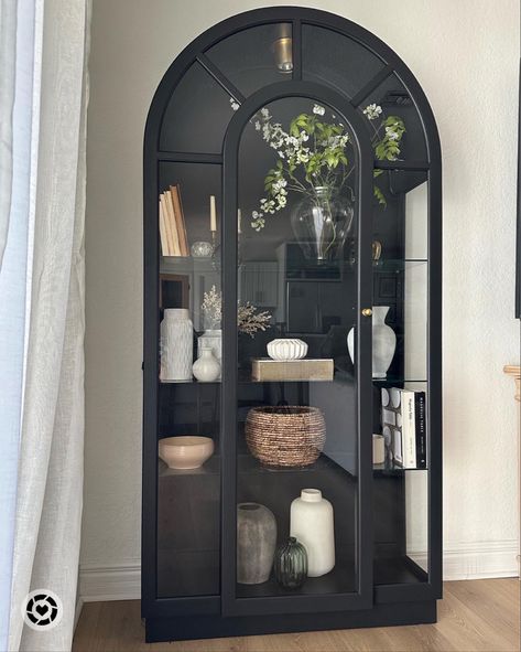 Curio Cabinet Displays Farmhouse, Curio Cabinet Styling Ideas, How To Style Curio Cabinet, Black Arched Cabinet Dining Room, Black Arched Glass Cabinet, Display Cabinet With Glass Doors, Black Arched Cabinet Styling, Crystal Cabinet Display, Black Display Cabinet Living Room