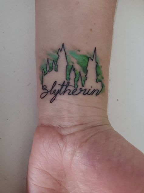 Hogwarts house slytherin tattoo. Harry Potter #harrypottertattoo #slytherin #slytherintattoo #harrypottertattoosmall #hogwartstattoo Slytherin Tattoo Ideas Hogwarts Houses, Hogwarts House Tattoo, Small Slytherin Tattoo Ideas, Harry Potter House Tattoos, Slytherin Tattoo Ideas Minimalist, Tattoo Ideas Slytherin, Harry Potter Slytherin Tattoo, Slytherin Tattoo Minimalist, Harry Potter Tattoos Slytherin