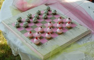 Polymer clay cupcakes on a distressed checker board. Clay Chess Board Diy, Ceramic Checkers Board, Clay Board Game, Clay Checkerboard, Clay Chess Set, Clay Chess, Cottagecore Cafe, Polymer Clay Cupcake, Chess Boards