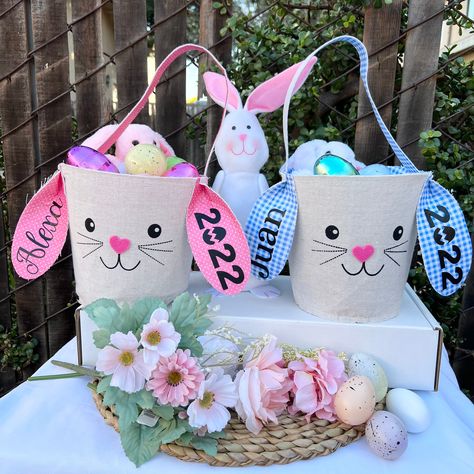 Customize Easter baskets 2022 Customize your little one Easter basket, she (he ) will have a lot of fun with this cute Easter Basket Choose one of two colors , pink or blue Name is placed on one ear, year on the other ear the price varies depending on your customization -choose your favorite font for the name - pick basket color with name and year or with out it - please basket is customized with HTV vinyl FREE SHIPPING AFTER $35 DOLLARS OR MORE Handmade with love Martha loves craft Baskets 2022, Blue Easter Basket, Pink Easter Basket, Custom Easter Baskets, Basket Blue, Disney Keychain, Unisex Christmas Gifts, Blue Names, Easter Fabric