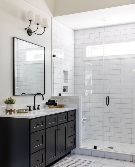 Windows in showers create a great source of natural light for a bathroom, and this one allows for privacy too 👍️ 🚿⁠ ⁠ ⁠ #blackandwhite #naturallight #bathroominspo #bathroomdecor #bathroom #bathroominspiration #bathroomgoals #blackandwhitebathroom Farmhouse Black And White Bathroom, Windows In Showers, Farmhouse Primary Bathroom, Modern Farmhouse Black And White, Farmhouse Black And White, Modern Farmhouse Black, Standing Tub, Black And White Bathroom, Primary Bathroom