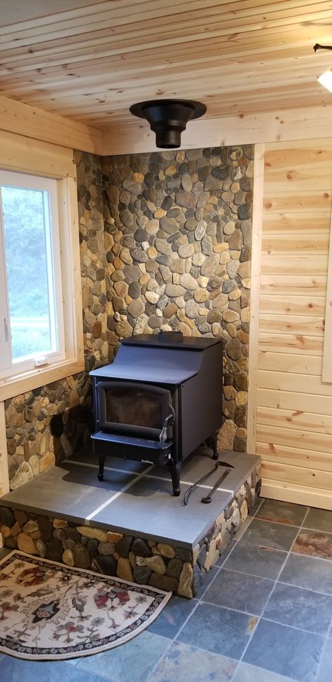 Hand picked river stone over tile board woodstove hearth. Wall Behind Woodstove, Woodstove Hearths, Woodstove Ideas, Diy Stone Wall, Corner Wood Stove, Hearth Ideas, Stove Hearth, Stove Wall, Backing Ideas