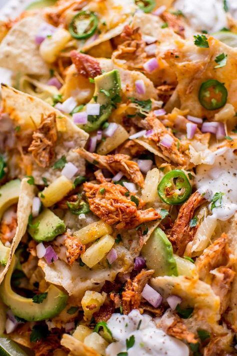 These tropical chicken nachos are a fun and tasty appetizer! Sweet and spicy chicken, pineapple, lime, avocado, sour cream, jalapenos, and lots of gooey cheese are a great combination of freshness and comfort. Pineapple Nachos, Pineapple Recipes Dinner, Appetizer Sweet, Bacon Nachos, Tropical Chicken, Avocado Sour Cream, Munchies Recipes, Baked Nachos, Chicken Pineapple