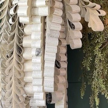 gina luker | arts + crafts on Instagram: "Book page vines… but make the pose-able? Some florists wire is the secret - you can even tape wires together if you want the even longer. Just cut strips 2 inches wide from book pages - then use staples to attach to each other by stapling over the wire. I’ve made these before - but this version is even better🌿 Don’t they look like something from Anthropologie?" Book Page Leaves, Book Paper Decorations, Book Page Centerpieces, Book Page Garland Diy, Book Page Decorations, Crafts With Book Pages, Storybook Backdrop, Book Garland, Upcycled Books Crafts