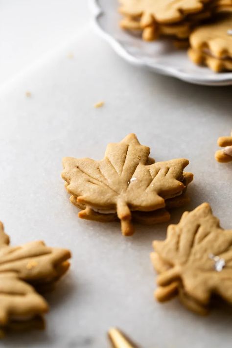 Easy and delicious maple leaf cookies, inspired by Canadian maple cookies filled with maple buttercream and simply decorated with edible gold. A wonderful treat for the fall season and for upcoming fall gatherings. Dairy free option included. Maple Leaf Cookies Decorated, Maple Leaf Cookies, Maple Buttercream, Maple Cookies, Leaf Cookies, Fall Gathering, Fall Mood, Edible Gold, Canadian Maple