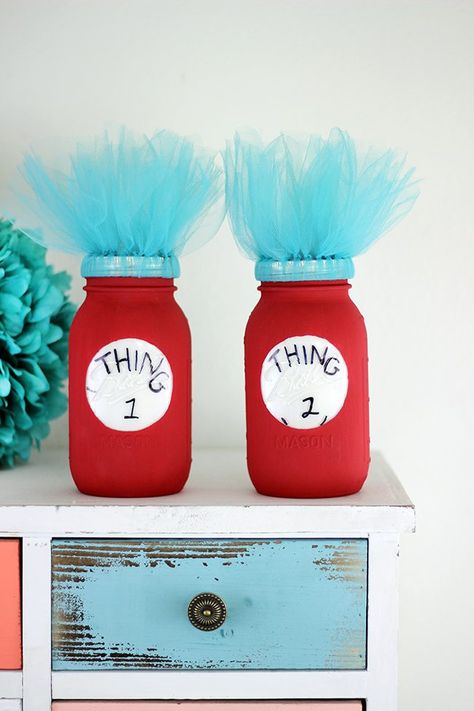 Dr. Seuss fan? Add a pop of fun to a room or party with these DIY Thing 1 and Thing 2 Mason Jars. So adorbs! Thing One And Thing Two Party Ideas, Thing One And Thing Two Birthday Ideas, Thing One And Thing Two Birthday, Dr Seuss Decorations, Dr Suess Baby, Thing One And Thing Two, Doctor Suess Birthday, Cat In The Hat Party, Dr Seuss Crafts