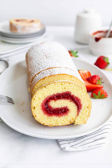 Strawberry Swiss Roll Cake recipe is easy to make. A spongy, fluffy cake filled with quick, homemade strawberry jam. Perfect for picnics and celebrations. Learn how to make it with a quick video that is included in the post. #strawberry #strawberries #strawberryswissroll #swissrollcake #rollcakerecipe #strawberryswissrollcake #springdesserts #summerdesserts Strawberry Swiss Roll Cake, Strawberry Swiss Roll Cake Recipe, Swiss Roll Cake Recipe, Strawberry Swiss Roll, Roll Cake Recipe, Strawberry Roll Cake, Sponge Cake Filling, Resepi Biskut, Swiss Roll Cake