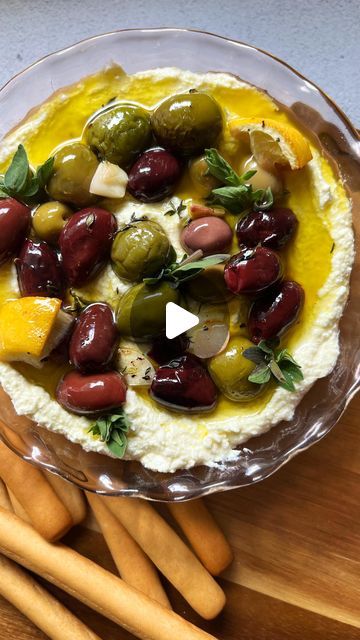 Corrina Cafarelli | The Charcuterie Queen on Instagram: "My olive lovers, this one’s for you!🫒
I am a new found olive lover myself and this dip hits the spot! Creamy feta, salty olives with fresh herbs, what more could you ask for? You can quickly whip this dip for any gathering and your guests will love it🌿

Ingredients:
- Kalamata Olives
- Italian Mix Olives
- Fresh Lemon
- Garlic
- Fresh Thyme, Oregano, and Dill 
- Olive Oil
- Salt & Pepper 
- Feta
- Cream Cheese

This is a super easy dip to make! The longest part is waiting for the olives to be fully marinated/ cooked. To make your roasted marinated olives combine your olives in a dish and add fresh lemon, chopped garlic, and all your fresh herbs, top with olive oil, salt and pepper. Place into the oven at 400 degrees for about 10-15 Super Easy Dips, Easy Dips To Make, Creamy Feta, Easy Dip, Marinated Olives, Olive Recipes, Mediterranean Food, Kalamata Olives, Chopped Garlic