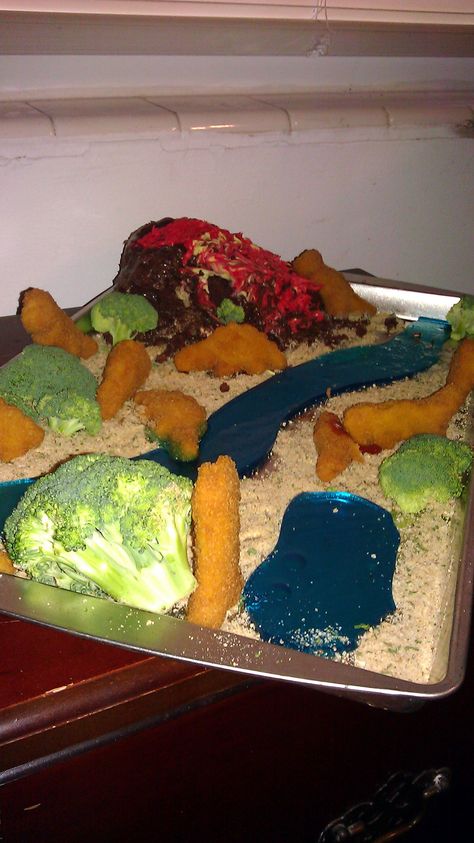 Dinosaur habitat from dino nuggets, broccoli, jello river, and a delicious volcano cake! Wow. Mashed Potato Volcano, Potato Volcano, Dinosaur Habitat, Dino Nuggets, Cheer Flyer, Volcano Cake, Mash Potato, Mashed Potato, Volcano