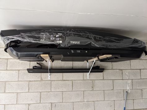 - Thule Motion XT XL Cargo Box - Everbilt 20" Heavy Duty Shelf Brackets - Home Depot - Tapcon 1/4-inch x 1-3/4-inch Ultrashield Slotted Hex Washer Head Concrete Anchors in White - 10 Pack - Home Depot - Scrap wood (had leftover smooth shelving particle boards) cut to 36" x 3.25" - Wood screws Cargo Box Storage Garage, Roof Box Storage Ideas, Thule Storage, Roof Box Storage, Garage Cupboards, Car Roof Box, Garage Ceiling Storage, Garage Design Interior, Concrete Anchors