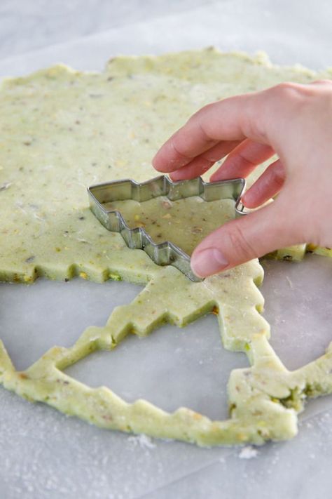 Dec 22, 2020 - Holiday baking season is upon us, and these pistachio-flavored cutout cookies are the perfect canvas for holiday decoration. These incredibly soft, subtly green sugar cookies are flecked with bits of chopped pistachios and decorated with Butter Pecan Roll Out Cookies, Pistachio Cut Out Cookies, Rolled Out Cookies, Flavored Roll Out Cookies, Pistachio Sugar Cookies, Flavored Sugar Cookies Cut Outs, Sugar Cookie Flavor Ideas, Flavored Cutout Cookie Recipe, Cutout Cookie Flavors