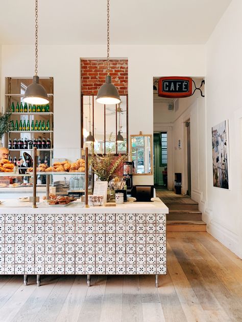 Coffee shop with tile details. White and brick walls. Wood floor. Lots of pastries. Latin Coffee Shop, Spanish Style Coffee Shop, Mediterranean Coffee Shop, Coffee Shop Tile, Italian Cafe Aesthetic, Bakery Aesthetic Interior, European Coffee Shop, Mexican Coffee Shop, Coffee Moodboard