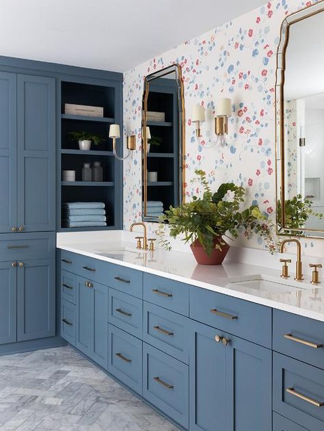 A blue shaker double vanity dons brass pulls and antique brass faucets mounted beneath French mirrors lit by glass and brass sconces and hung from a wall covered in Lake August Nasturtium wallpaper. Nasturtium Wallpaper, Herringbone Bathroom Floor, Blue Hexagon Tile, Marble Herringbone Floor, Antique Brass Bathroom Faucet, French Mirrors, Antique Brass Faucet, Brass Faucets, Polished Nickel Faucet