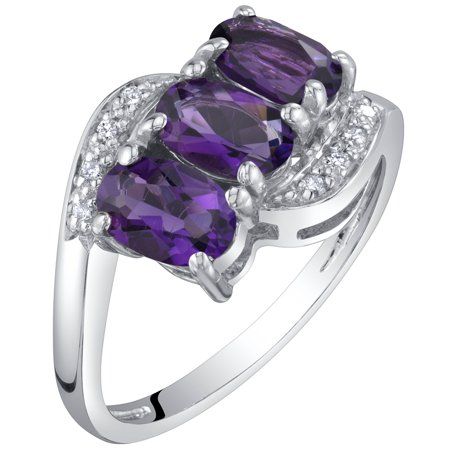 Adorn yourself or a loved one with this 1.25 ct Oval Amethyst and Diamond Three-stone Anniversary Ring in 14K White Gold. This ring features exquisite 1.25 carat total weight natural Amethyst gemstones. Precisely cut and crafted, the oval shape Amethyst gemstone, measuring 6 x 4 mm, radiates a vibrant purple color. This three-stone style ring features a secure prong setting and is accented with dazzling diamond side stones. The diamond accent stones are brimming with beauty with an I1 clarity an Gem Engagement Rings, Colored Stone Engagement Rings, Jewelry Questions, Moonstone Engagement Ring Set, Special Engagement Ring, Gemstone Diamond Ring, Precious Rings, Amethyst And Diamond Ring, Moonstone Engagement Ring