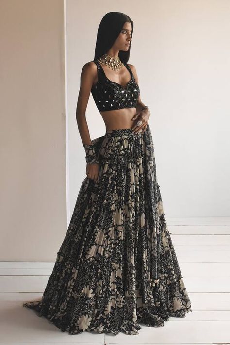 Black organza tiered lehenga with garden print. Comes with a mirror embroidered net blouse and a georgette dupatta. Components: 3 Pattern: Printed, Embroidered Type Of Work: Garden, Mirror Neckline: Sweetheart Sleeve Type: Sleeveless Fabric: Lehenga : Organza, Blouse : Net, Dupatta : Georgette Color: Black Other Details:  Closure : Blouse - Back hooks and Drawstrings Occasion: Sangeet - Aza Fashions Black Indian Outfit, Lehenga Black, Arpita Mehta, Haldi Outfits, Crop Top Lehenga, Black Lehenga, Bridesmaid Saree, Net Blouses, Punjabi Outfits