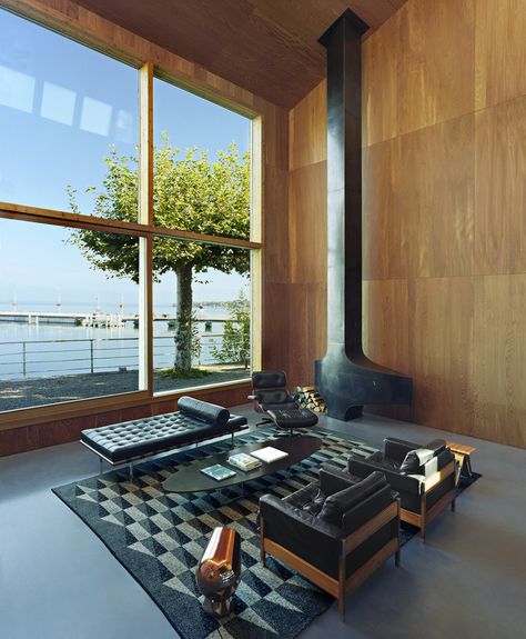 The 6,780-square-foot interior is completely lined in larch, a wood grown in the surrounding Alps and selected to give the feeling of an Alpine home. The metal fireplace was bought off-the-shelf from the French fireplace company Focus. ‘The model is from the ‘70s, made for a French ski resort,’ Mr. Dentand says. Barcelona Couch, Eames Coffee Table, Leather Daybed, Interior Minimalista, New York Apartment, Lake Geneva, Interior Design Magazine, Steel House, Decorating Inspiration