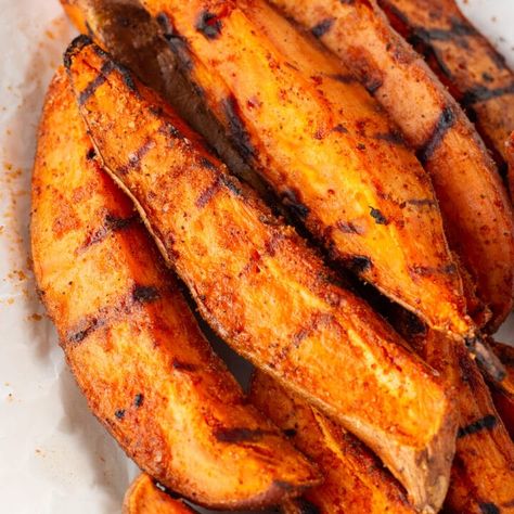 These grilled sweet potato wedges are a cinch to make, using a simple homemade potato seasoning that results in a sweet and smoky flavor. Great with the typical burgers and hot dogs, but also other grilled meats, they're perfect for dipping into ketchup, BBQ sauce, or any other condiment of your choice. Whether it's a casual family weeknight dinner or a lively weekend cookout, these bbq sweet potato wedges are sure to be a hit. Grilled Sweet Potato Wedges, Grilling Sweet Potatoes, Sweet Potato On Grill, Sweet Potato Grilled, Bbq Sweet Potato Recipes, Blackstone Sweet Potatoes, Grilled Sweet Potato Recipes, Bbq Sweet Potato, Grilled Sweet Potato Fries