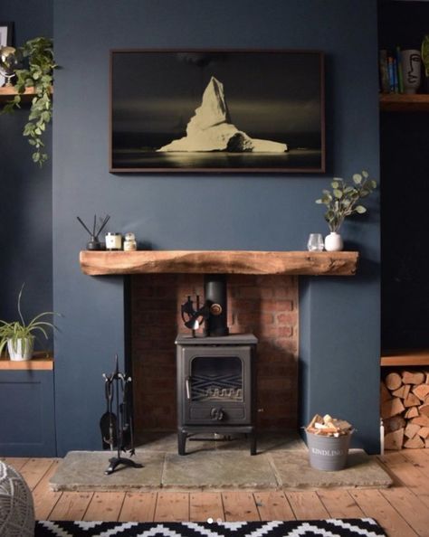 With a modern sensibility, some smart editing, and a hint of rustic blue, you can create a space that feels alive with color and rich in history at the same time. Here's how. #hunkerhome #blue #blueinterior #bluepaint #bluewalls Blue Living Room Ideas, Log Burner Living Room, Navy Living Rooms, Feature Wall Living Room, Snug Room, Dark Living Rooms, Living Room Decor Fireplace, Cottage Living Rooms, Cosy Living Room