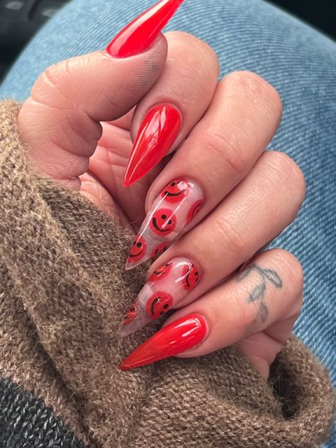 Stiletto nail shaped painted red with smiley faces painted on the ring and middle finger. Red Smiley Face Nails, Red Stiletto Nails Designs, Smiley Nails, Smiley Face Nails, Red Stiletto Nails, Acrylic Nails Stiletto, Face Nails, Red Gel Nails, Bright Red Nails