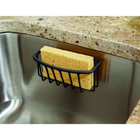 "Buy the Kitchen Details Sponge Holder at Michaels. com. This compact sponge holder is a great accessory to keep your sponge handy, dry, and organized in your sink. This Kitchen Details compact sponge holder is a great accessory to keep your sponge organized in your sink. The open wire design allows water to drain preventing water build up and mildew. It easily mounts against a smooth, flat surface with two suction cups. No tools needed! Details: Available in assorted colors 5.5\" x 2.6\" x 2.4\ Portable Shelves, Sponge Organizer, Kitchen Sponge Holder, Monday Inspiration, Kitchen Details, Wire Design, Sponge Holder, Easter Shopping, Christmas Tree With Gifts