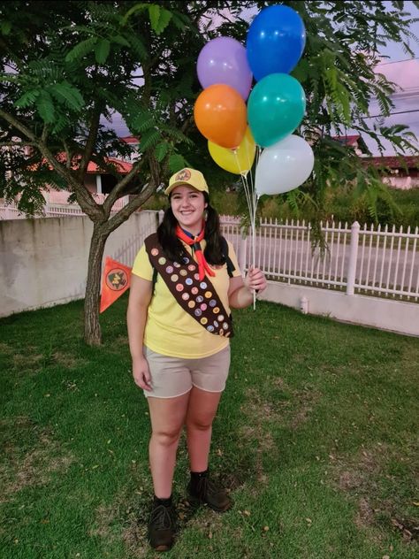 she's wearing a yellow shirt, brownish shorts, combat boots, a brown ribbon full of scout badges and she's holding balloons Russel Up Costume Diy, Russel Costume, Russell Up Costume, Russell Costume, Bike Night, Movie Character Costumes, Up Movie, Up Costume, Diy Costume