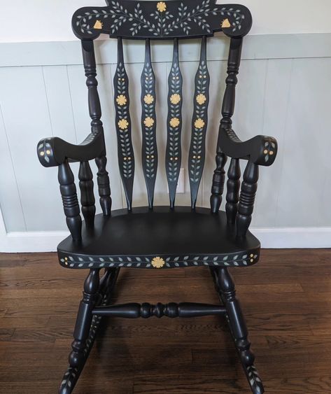 Large, solid wood, and super sturdy rocking chair. This is a repaint of my first rocking chair since I've decided to keep the last wooden one for now! The base color is a charcoal that appears more like dark blue in bright lighting. Lots of hand painted leaves, yellow flowers, and little gold details. 🌼 #handpaintedfurniture #handpaintedchair #handpaintedrockingchair #vintagerockingchair #rockingchair #accentchair #nurserydecor #nurserychair #fusionmineralpaint #colorfulhome #interiordesign ... Painted Chairs Ideas, Christmas Chairs, Blue Rocking Chair, Rocking Chair Makeover, Painted Rocking Chairs, Scandi Furniture, Hand Painted Chairs, Vintage Rocking Chair, Cottagecore Home