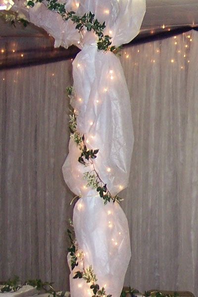 Gossamer and tulle are a way to decorate the wedding and reception venues with inexpensive elegance. Wedding Arch Tulle, Tulle Wedding Decorations, Pillar Decor, Tulle Decorations, Fun Wedding Decor, Lights Wedding Decor, Wedding Ceremony Ideas, Arch Decoration Wedding, White Lights