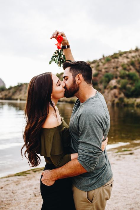 Christmas Couple Mistletoe, Under The Mistletoe Pictures, Holiday Couple Photoshoot Ideas, Mistletoe Picture Couple, Cute Couple Holiday Pictures, Outdoor Christmas Photoshoot Ideas Couple, Couples Kissing Under The Mistletoe, Mistletoe Pose Reference, Mistletoe Photoshoot