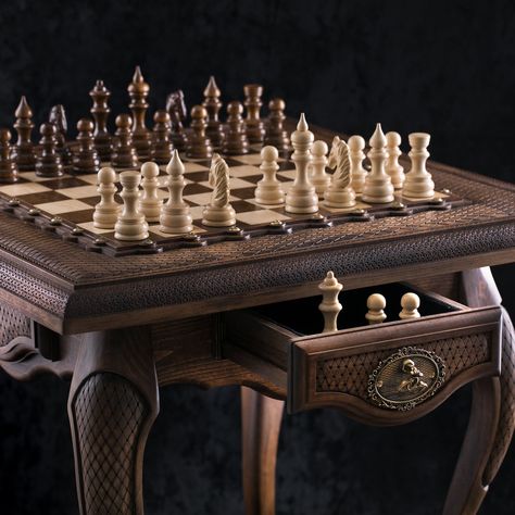 Crafted from the finest materials, our Classic Chess Table stands as a tribute to the timeless allure of artisanal craftsmanship. Each element of the table's frame, meticulously shaped and finished by hand, reflects the artisan's unwavering commitment to precision and intricacy. The rich, natural hues of the wood infuse warmth into any space, while the carefully chosen grains imbue each piece with its own distinct charm and character. The playing surface of the table epitomizes the marriage of f Chess Board Table, 3d Chess, Chess Boxing, Wood Chess Board, Wooden Chess Board, Chess Table, Wood Chess, Table Handmade, Wooden Chess