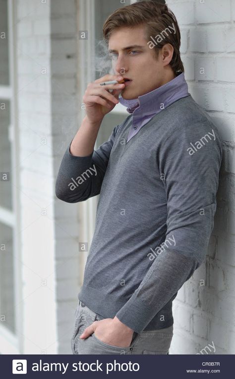 Man leaning on a wall, smoking Stock ... Guy Leaning Reference, Smoker Pose Reference, Man Leaning On Wall Pose, Guy Leaning On Wall, Guy Leaning Against Wall, Leaning On Wall Pose Reference, Leaning On Wall Pose, Person Leaning Against Wall Reference, Holding Ciggerate Reference