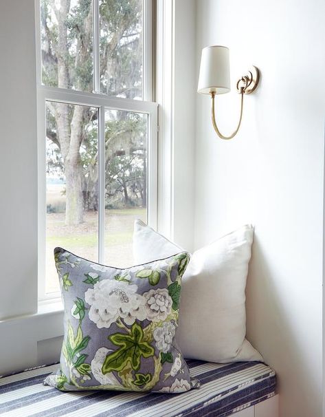 Reed Single Sconce lights a window seat nook boasting a white built-in window seat topped with a white and black striped seat cushion. Cottage Den, Wall Seat, Blue Plaid Pillows, Window Seat Nook, Bedroom Window Seat, Window Storage, Den Library, Built In Window Seat, Window Seating