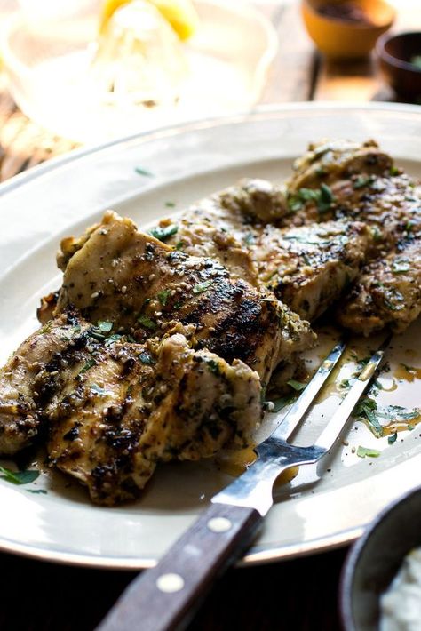 NYT Cooking: This recipe was inspired by the Middle Eastern dried seasoning mix called za’atar, a combination of herbs (usually thyme, oregano and marjoram), sesame seeds and sumac, often spiked with salt. Here, fresh herbs are substituted for the dried, which, along with fresh parsley and mint and plenty of lemon and garlic, are used to marinated boneless chicken thighs. If you can’t ... Nytimes Cooking, Sumac Chicken, Garlicky Chicken, Middle Eastern Chicken, Anchovy Sauce, Chicken Grilled, Garlic Chicken Recipes, Za Atar, Herb Chicken