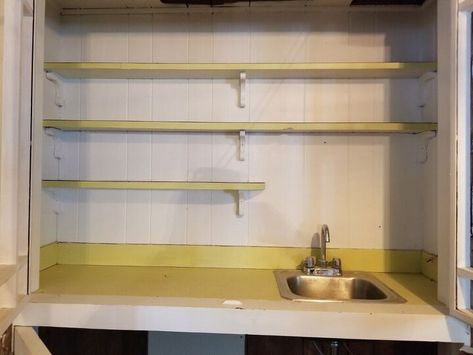 I had a built in wet bar that was straight out of the 70's. I gave it an inexpensive update with some contact paper and leftover wallpaper. We had a wet bar in our house that was outdated. It needed an major overhaul! We have so many major projects on our to do list so I was looking for a quick and inexpensive solution. I started by removing the old shelves. They were not only ugly, but too narrow and pretty useless. Once I got the shelves removed, I was ready to clean it up and… Wet Bar Makeover, Old Shelves, Round Side Table Makeover, Leftover Wallpaper, Birthday Photo Displays, Bar Makeover, Secretary Desk Makeover, Built In Wet Bar, Side Table Makeover