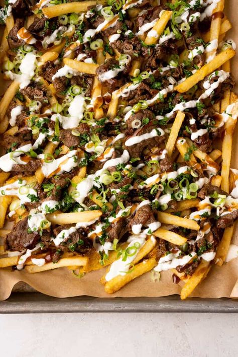 Loaded fries with steak are salty, savory, and saucy; crispy fries topped with juicy ribeye and drizzled with a creamy lime garlic sauce. Steak Loaded Fries, Fries With Steak, Beef Loaded Fries, Shaking Beef, Shoestring Fries, Steak And Rice, Thai Basil Chicken, Red Curry Chicken, Crispy Fries