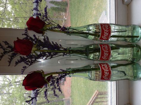 Does anyone else think glass Coke bottles are too pretty to throw away?  Well here is a new use for them, vases! Glass Coke Bottle Crafts, Coke Bottle Decor, Coke Bottle Crafts, Glass Coke Bottles, Soda Bottle Crafts, Bottle Picture, Coke Cola, Hobbit Hole, Bottle Candles