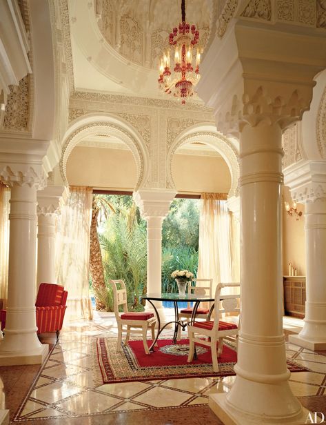 With exposed wood beams, textured walls, and a 17th-century Italian walnut front door, this foyer is composed of traditional Mediterranean elements. The Malibu beach house was devised by architect Douglas Burdge and the owner of the home, designer Richard Shapiro. The sculptural staircase is a modern contrast to the 19th-century replica of an ancient Greek statue at its base. Greek Style Home, Mediterranean Room, Mediterranean Furniture, Mediterranean Home Interior, Rustic Mediterranean, Mediterranean Mansion, Mediterranean Interior Design, Mediterranean Aesthetic, Mediterranean Interior