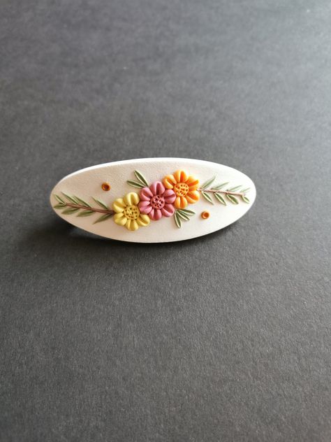 This design is completely handmade with each flower and leaf made individually, no molds have been used. I make each hair clip by hand with high quality polymer clay.  The metal clip is a french barrette with a secure clasp.  The length of the metal clip is approximately 2.5 inches (6.35cm) and the total length of the hair clip is 3.375 inches (8.5cm).  This design is one of a kind in its colour blends and can not be duplicated. Hair clip/barrette care:  Do not apply hairspray or hair products o Polymer Clay Barrettes Diy, Polymer Clay Hair Clips, Clay Hair Clips, Clay Hair, Beaded Hair Clips, Floral Hair Clip, Handmade Hair Clip, Clay Baby, Baby Hair Clips