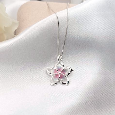 This Sterling Silver Rainbow Plumeria Necklace is the perfect accessory for anyone looking to add a touch of Hawaiian-inspired style to their look. Crafted with 925 sterling silver, this beautiful necklace features a colorful plumeria flower surrounded by intricate detail. The ideal beach gift, this plumeria pendant is sure to make a lasting impression. - Comes ready to wear on a 925 sterling silver chain of your choice length. Comes standard on a box style chain.  - solid sterling silver plumeria flower pendant accented with a faux pearl   Approx 20 mm in size Custom made to order so yours may look slightly different from the above pictures. Due to different monitors and settings colors may appear slightly different. Jewelry Silver Necklaces, Silver Beach Jewelry, Cute Silver Jewelry, Plumeria Necklace, Silver Jewlery, Hawaiian Jewelry, Jewelry Flower, Jewelry Accessories Ideas, Dope Jewelry