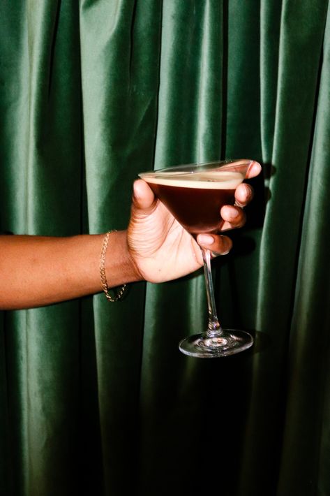 hand holding espresso martini in front of green velvet curtain, cocktail, hoxton spirits, banana rum, Espresso Martini Photography, Expresso Martini Aesthetic, Espresso Martini Aesthetic, Banana Rum, Espresso Martini Recipe, Cocktail Illustration, Coffee Shot, Cocktail Photography, Coffee Liqueur