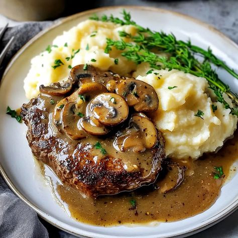 Try Bobby Flay's Salisbury Steak recipe! Juicy ground beef patties with mushroom gravy. Ready in 40 minutes! Perfect for weeknight dinners. Mushroom Sauce For Steak, Beef And Mushroom Recipe, Sauce For Steak, Easy Sunday Dinner, Salisbury Steak Recipe, Bobby Flay Recipes, Salisbury Steak Recipes, Beef Patties, Sunday Dinner Recipes