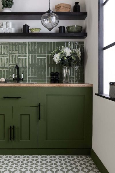 Introducing Hamlet brick tiles, featuring striking olive green colouring across a rustic, bumpy porcelain surface with a shining gloss finish. Perfect for your interior wall and floor designs, Hamlet's small format allows for a variety of layouts, creating a unique and dynamic look in any space. Order a sample at wallsandfloors.co.uk Olive Green Kitchen Tiles, Green Kitchen Brick Backsplash, Green Backsplash Kitchen White Cabinets, Backsplash For Green Cabinets, Green Tiled Kitchen, Green Tile Kitchen Backsplash, Green Backsplash Kitchen, Green Kitchen Tiles, Green Metro Tiles