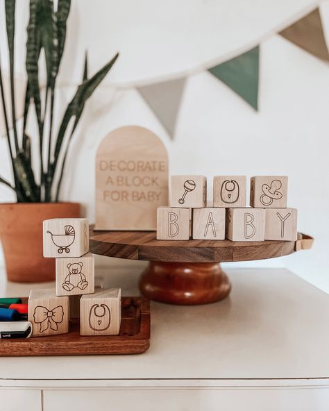 Wooden baby blocks with baby related images engraved onto the wood for guests to decorate at a baby shower for an activity Block Decorating Station, Baby Shower Block Decorating, Minimalist Baby Shower Decor, Baby Blocks Baby Shower Diy, Baby Shower Welcome Table, January Baby Shower Ideas, January Baby Shower, Decorate A Block, Welcome Baby Signs