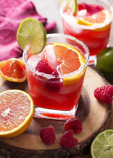 For an easy summer cocktail, try a raspberry orange margarita! Limes, orange juice, raspberry syrup, and triple sec on the rocks. Great for Cinco de Mayo, as for Valentine's, or as an anytime drink! | justalittlebitofbacon.com #summerrecipes #cocktails #drinks #margaritas #valentines #cincodemayo Cocktails With Raspberry Syrup, Raspberry Syrup Cocktail, Valentines Margaritas, Fruity Summer Drinks, Raspberry Margarita, Orange Margarita, Valentine Drinks, Drink Candles, Raspberry Cocktail