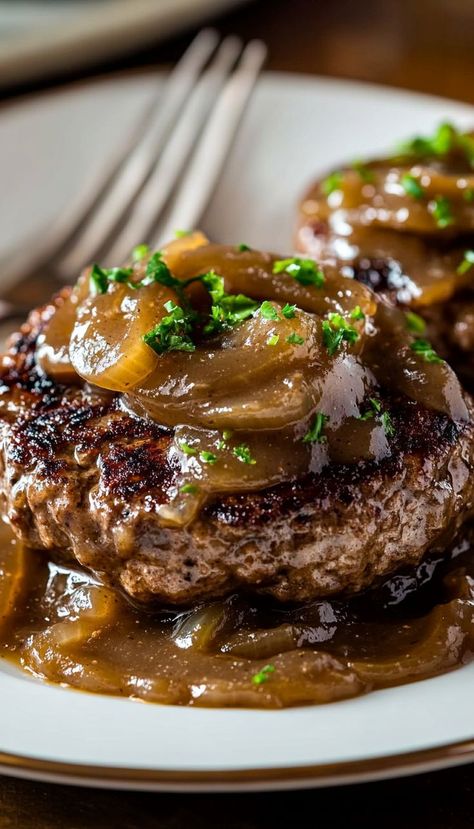 This Hamburger Steaks with Onion Gravy recipe is a comforting, hearty dish that’s perfect for a satisfying weeknight dinner. Juicy hamburger patties are smothered in a rich, savory onion gravy, creating a dish that’s bursting with flavor. Served over mashed potatoes or alongside rice, this meal is the epitome of comfort food. The gravy, made from caramelized onions and beef broth, adds depth and richness to the dish. Juicy Hamburger Patties, Hamburger Steaks With Onion Gravy, Onion Gravy Recipe, Hamburger Steak Recipes, Hamburger Steaks, Juicy Hamburgers, Over Mashed Potatoes, Beef Steaks, Hamburger Steak