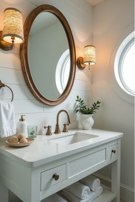 Beach-themed bathroom with shiplap walls and nautical vanity lighting Bathroom Mirror And Lighting Ideas, Diy Bathroom Vanity Makeover, Nautical Bathroom Design Ideas, Round Bathroom Mirror, Nautical Elements, Nautical Bathroom, Bathroom Vanity Makeover, Bathroom Vanity Designs, Diy Bathroom Vanity