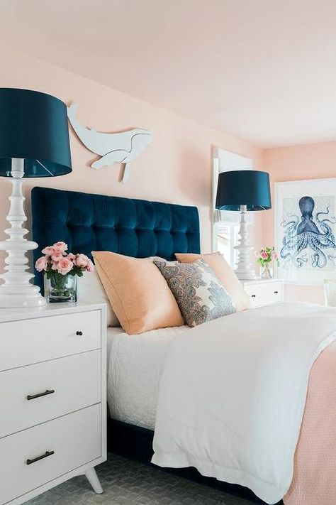 A white whale art piece hangs from a pink wall above a blue velvet tufted headboard accenting a bed complemented with white and pink bedding topped with pink and white pillows. Zimmer Diy, Blue Headboard, Hgtv Dream Homes, Hgtv Dream Home, Pink Bedrooms, Coastal Bedrooms, Room Deco, Bilik Tidur, Pink Bedroom